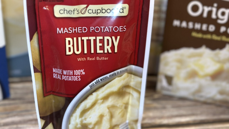 Chef's Cupboard mashed potatoes buttery package on table.