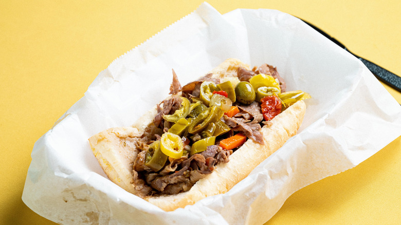 An Italian Beef sandwich resting on a piece of sandwich paper.