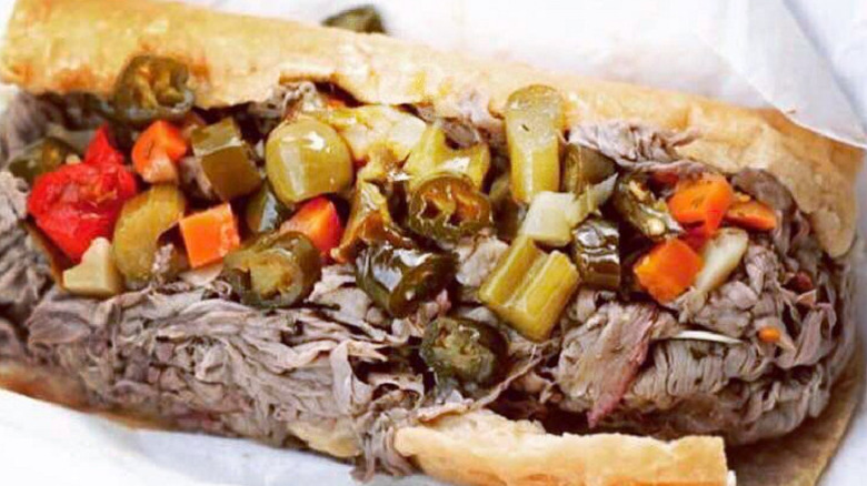 An Italian beef sandwich, sitting on wrapping paper.