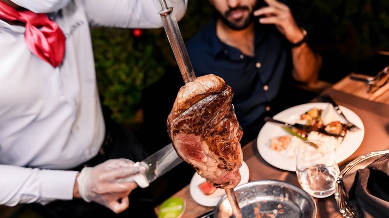 Cut of Alcatra meat on skewer