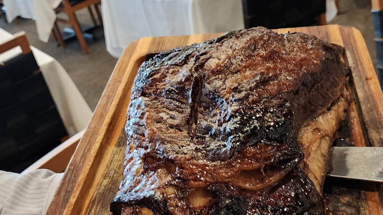 Smoked beef ribs on a wooden cutting board