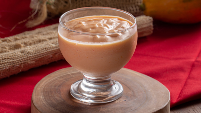 Small glass bowl filled with a tangerine colored cream.