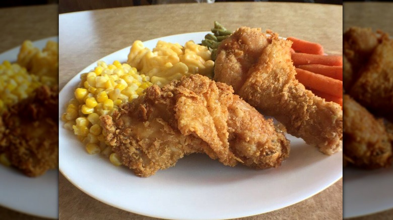 Plate of Golden Corral Fried Chicken with sides of maccaroni and cheese green beans carrots and corn