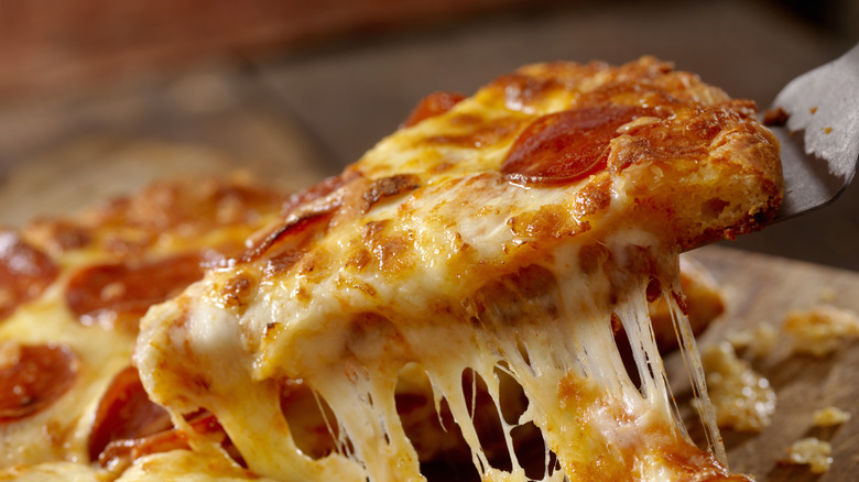 Pepperoni pizza slice with cheese pull