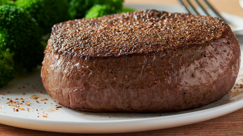 Outback center cut sirloin steak on a plate with broccoli