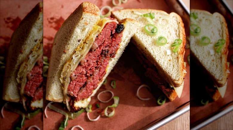Pastrami sandwich with slaw on red plate
