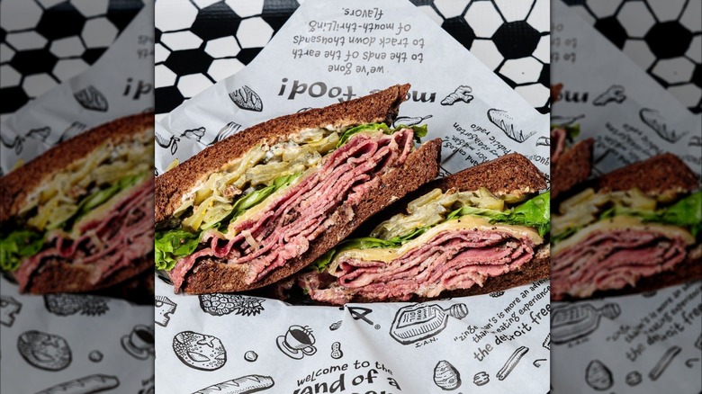 Zingerman's Delicatessen pastrami with Swiss and pickles in paper-lined basket