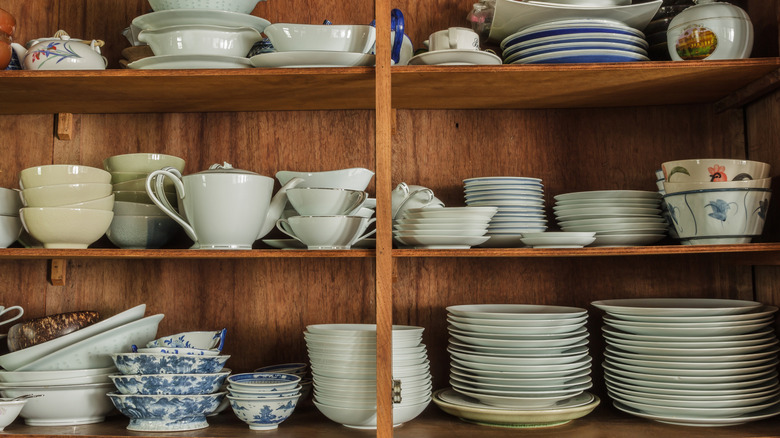 Wooden kitchen cabinet filled with dishes