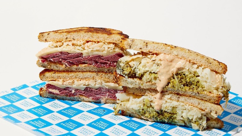Reuben sandwiches on blue and white paper