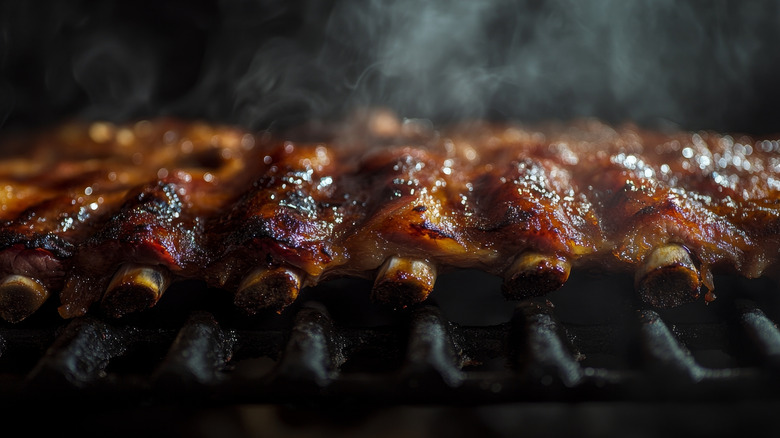 Barbecue ribs sizzle on a grill