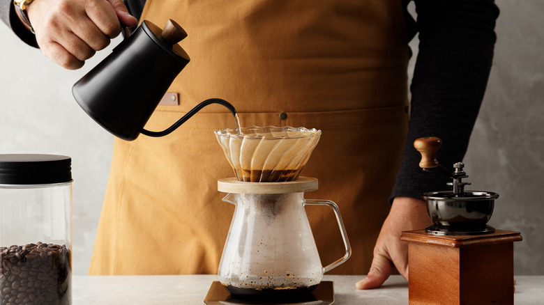 Man brewing pour over coffee
