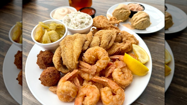 Fried seafood platter with catfish and shrimp on white plate