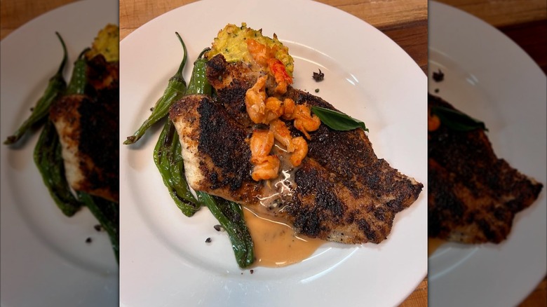 Blackened fish on a plate with sides