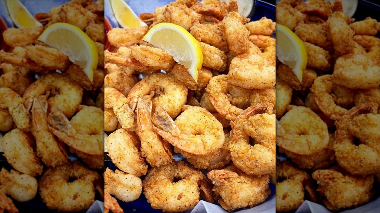 Basket of fried shrimp with lemon wedges