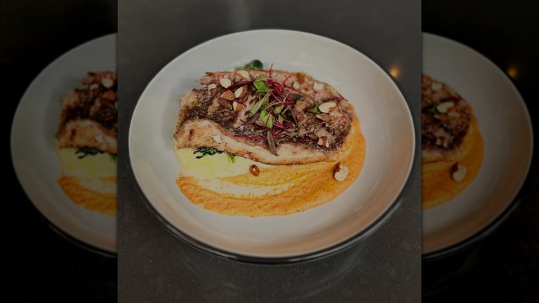 Cut fish on a plate with a sauce spread