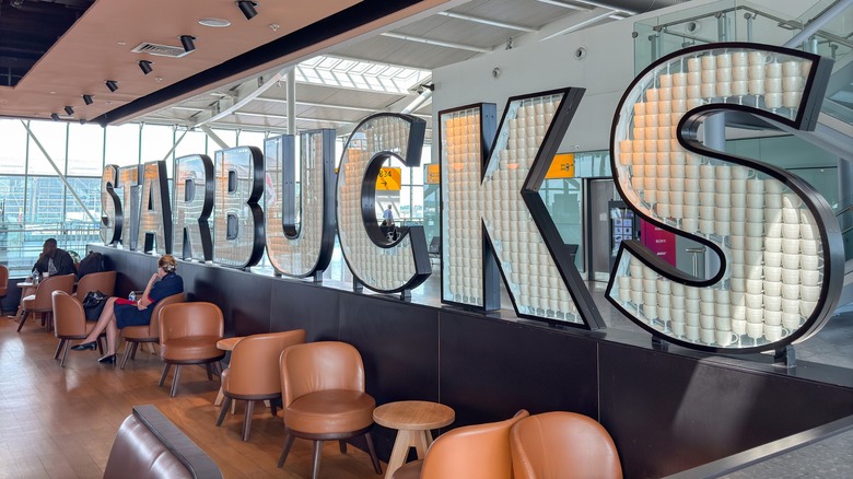 Large "Starbucks" lettering on wall in airport