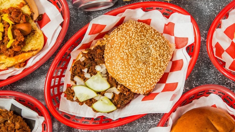 Farley's sloppy joe in red basket with sliced cucumber triangles