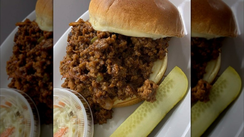 Pizzeria Aroma stuffed Sloppy Joe with pickle and side of slaw