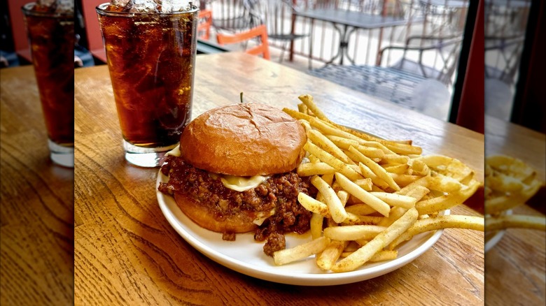 Vesper Lounge sloppy joe with fries and a soda in a glass