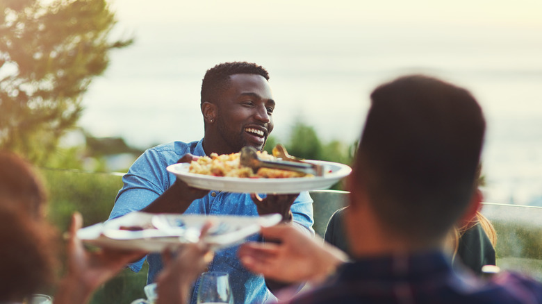 Friends gathering around the dinner table