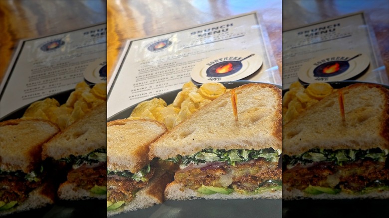 southern love fried green tomato BLT in front of restaurant menu