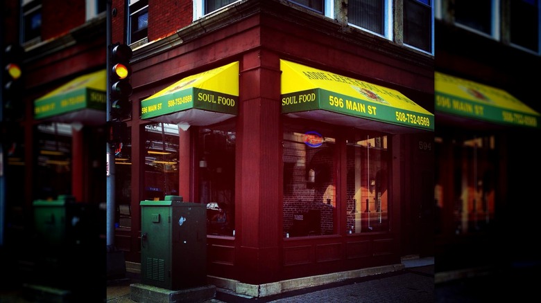 Storefront of Addie Lee's Soul food with yellow awnings and red facade on street corner
