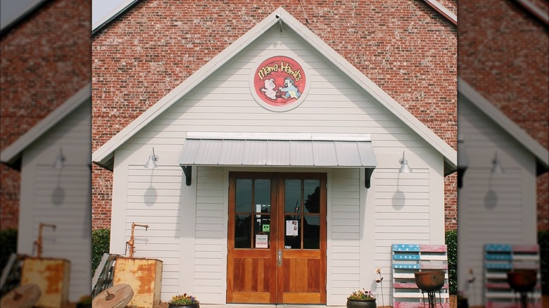 White pointed storefront of Mama Hamils in front of larger brick building