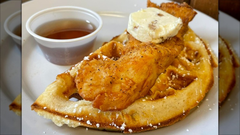Roost Fried Chicken and waffles on white plate with side of butter and syrup