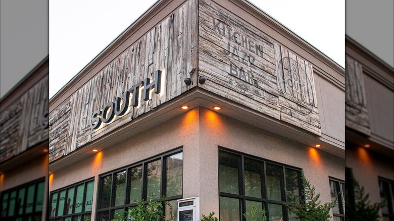 South Restaurant and Jazz Club storefront with restaurant name on wooden background and lights
