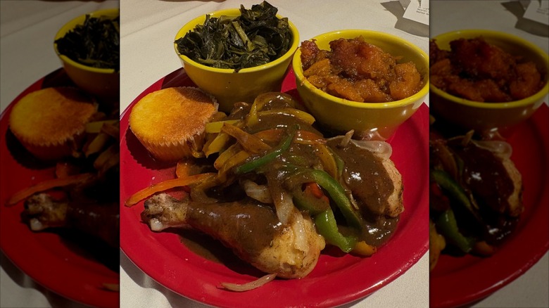 Mama J's kitchen chicken legs smothered in saucy vegetables with side of cornbread and collard greens