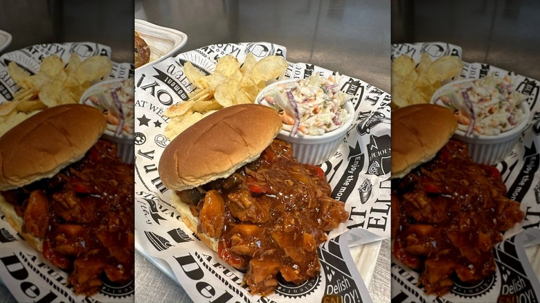 Sumthin' Good Soul food BBQ pulled pork sandwich with chips and coleslaw on paper lined tray