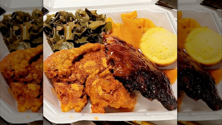 The Cozzy Corner fried chicken and barbecue ribs with collard greens and cornbread in styrofoam takeout container