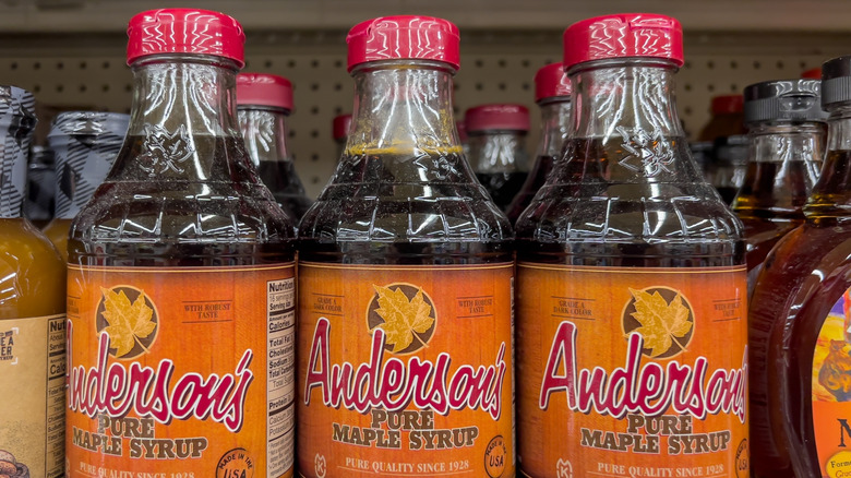 Bottles of Anderson's pure maple syrup on a store shelf.
