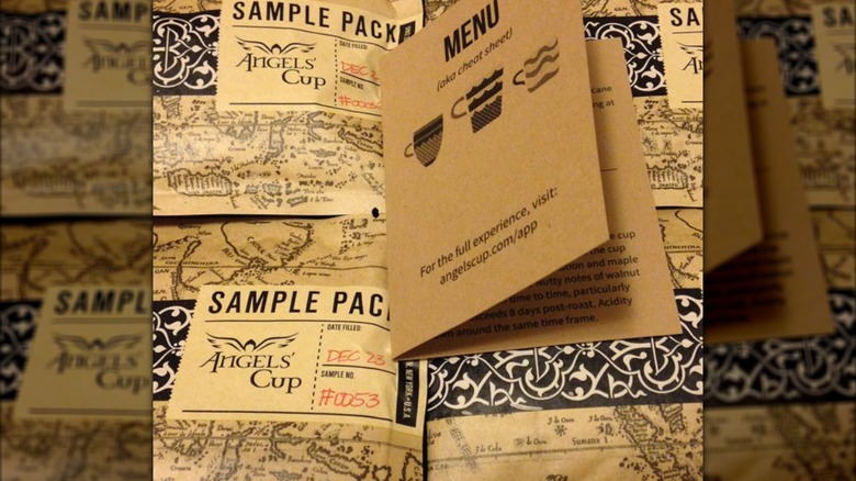 A brown menu lying on top of Angels' Cup sample packs