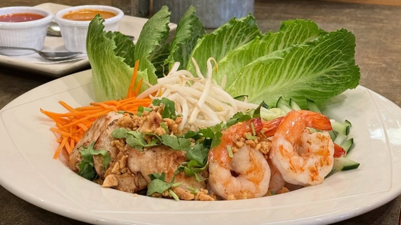 Thai lettuce wrap with shrimp and shredded carrots on table at Soybean Asian Grille