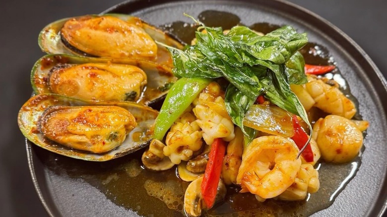 Holy Basil seafood Special at Thai Tree restaurant with mussels, shrimp, scallops, squid, onion, green and red peppers, and basil