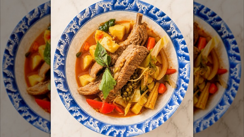 Ribs in the Jungle entree featuring Tender pork ribs, bamboo shoots, wild herbs, and spicy jungle curry from Boonnoon Market