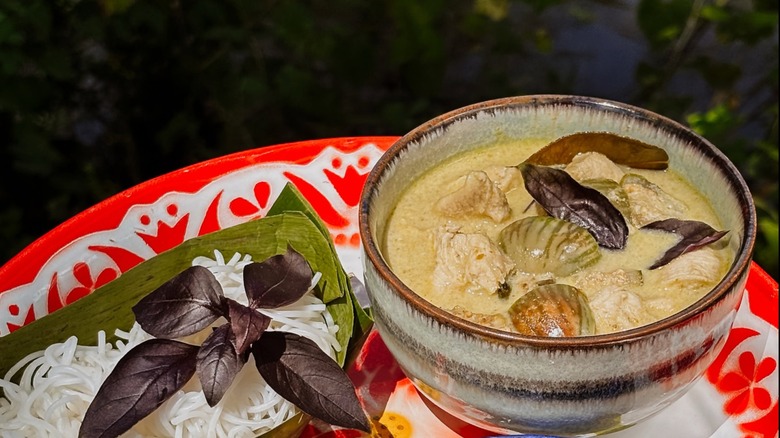 Thai curry dish in a decorative earthenware bowl at Dalaya Thai Cuisine
