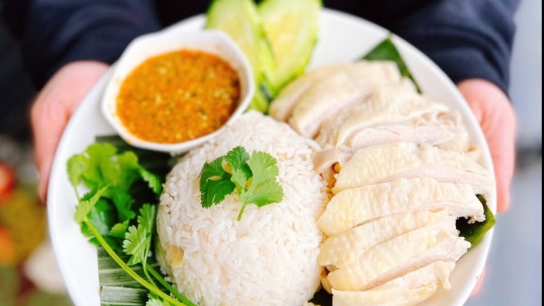 Thai dish with rice, chicken, and a curry from Aroy Mak Thai Food