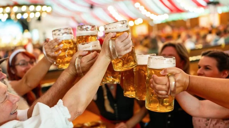 Patrons clinking beer pints at German restaurant East Side Restaurant