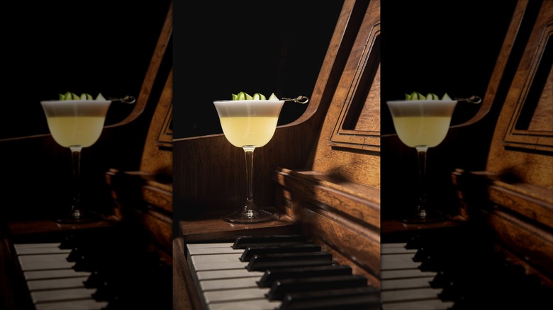 Piano with the Dillinger Sour cocktail from Vernon's Speakeasy placed on it