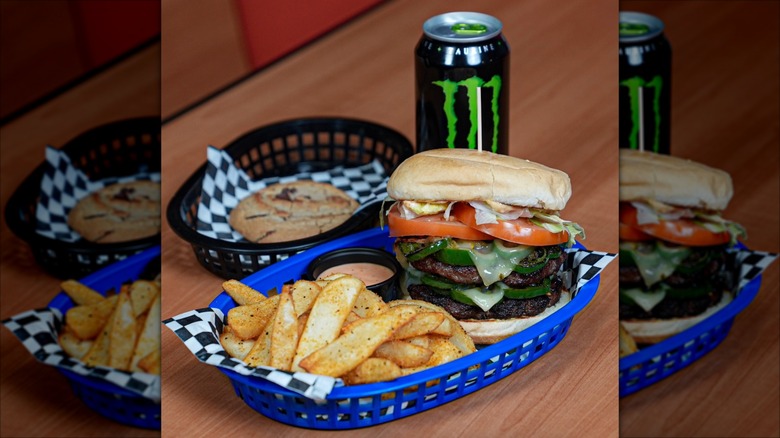 The Hellraiser burger from Burgertory SLC with fries, a cookie, and a Monster energy drink