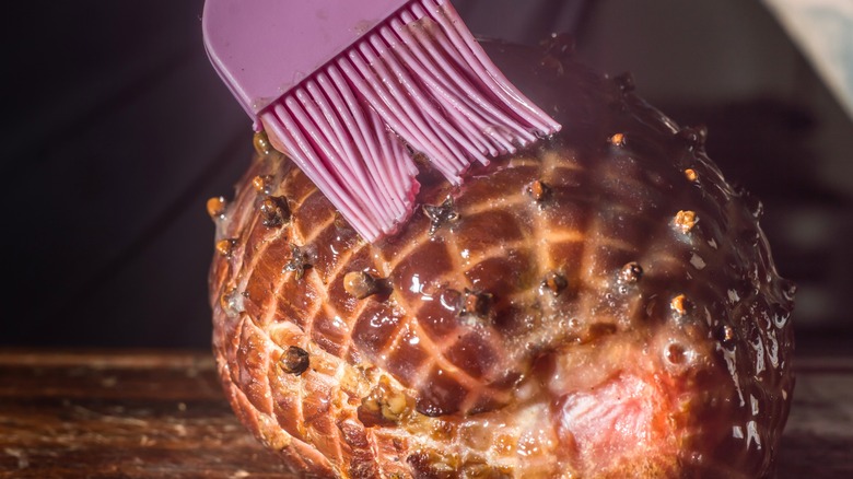 Silicone brush applying glaze to ham