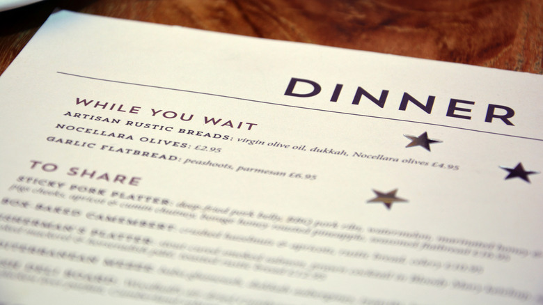 One page dinner menu on wooden table