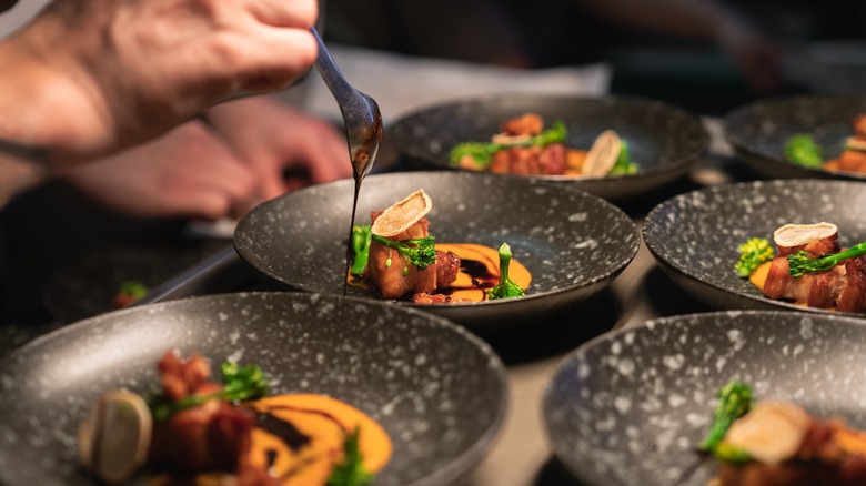 Chef plating dishes at a restaurant