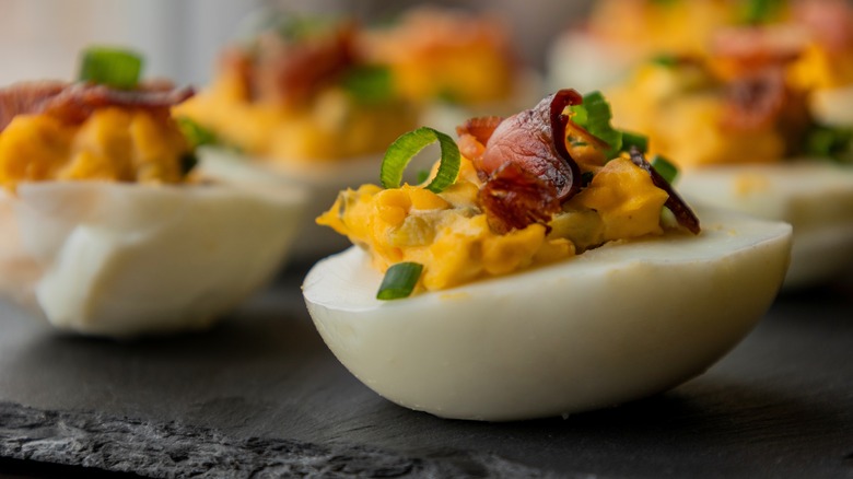 Deviled eggs with chunky filling and bacon