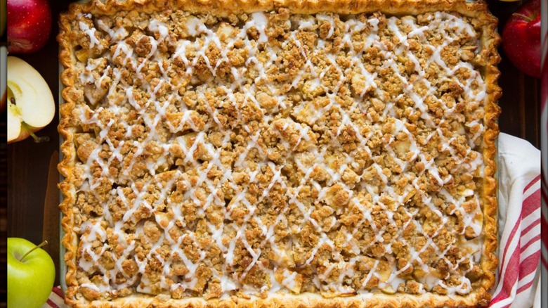 Large apple slab pie with crumble topping and icing