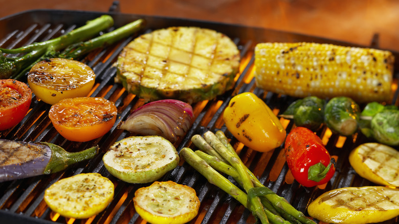 Assorted vegetables cooking on a grill