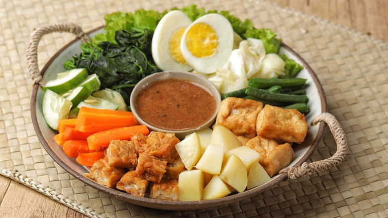 Indonesian gado-gado with assorted vegetables, boiled eggs, tofu, tempeh, and peanut sauce