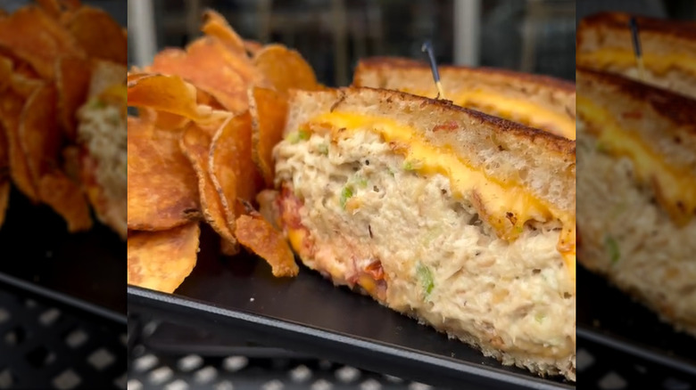 Mikey and Mel´s tuna melt cut in half with a side of potato chips